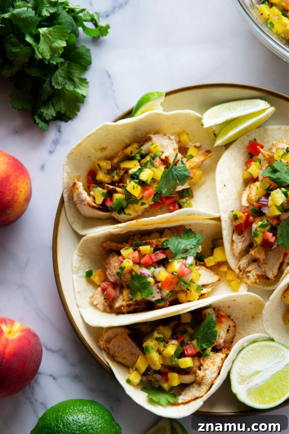 Smoky Blackened Chicken Tacos with Zesty Peach Salsa 2 Blackened chicken tacos feature a homemade blackened seasoning mix coating juicy chicken and a fresh spicy peach salsa on top.