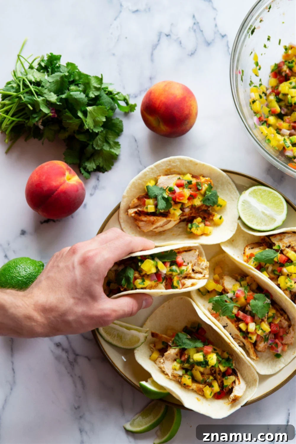 Smoky Blackened Chicken Tacos with Zesty Peach Salsa 6 Blackened chicken tacos feature a homemade blackened seasoning mix coating juicy chicken and a fresh spicy peach salsa on top.