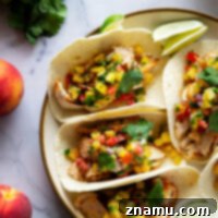 Blackened chicken tacos feature a homemade blackened seasoning mix coating juicy chicken and a fresh spicy peach salsa on top.