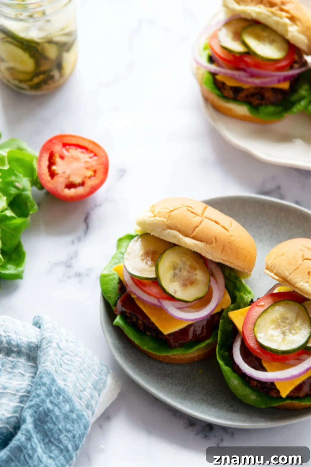 A stacked air fryer black bean burger on a bun with fresh toppings, ready to be enjoyed.