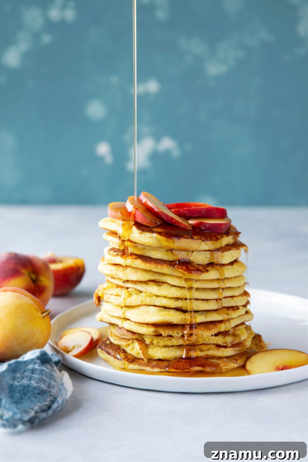 Golden Peach Cornmeal Pancakes 3 Juicy summer peaches and hearty cornmeal star in these tender, fluffy cornmeal peach pancakes that are a perfect stack for summer!
