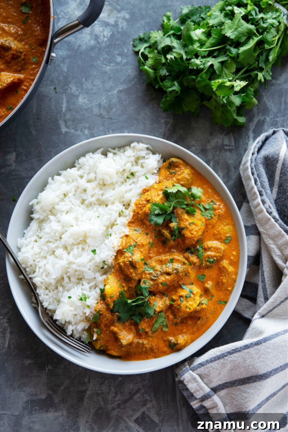 Creamy Mushroom Tikka Masala 2 Mushroom Tikka Masala served over fluffy rice with fresh cilantro garnish, showcasing tender yogurt-marinated mushrooms in a rich, spicy tikka masala sauce.