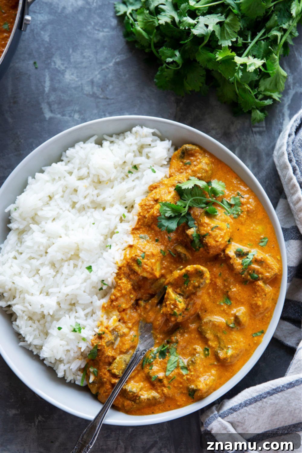 Creamy Mushroom Tikka Masala 6 A vibrant bowl of Mushroom Tikka Masala, showcasing its rich texture and color, garnished with fresh cilantro.