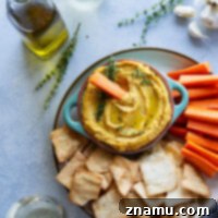 Flavorful roasted garlic and butternut squash gives this butternut squash hummus an unmatchable silky texture that you won't be able to keep those pita chips out of!