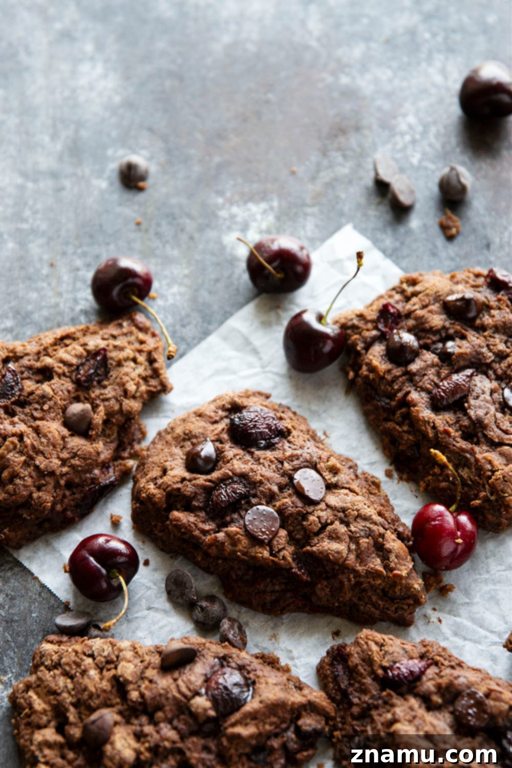 Decadent Double Chocolate Cherry Scones 6 A stack of warm Double Chocolate Cherry Scones with melted chocolate chips visible.