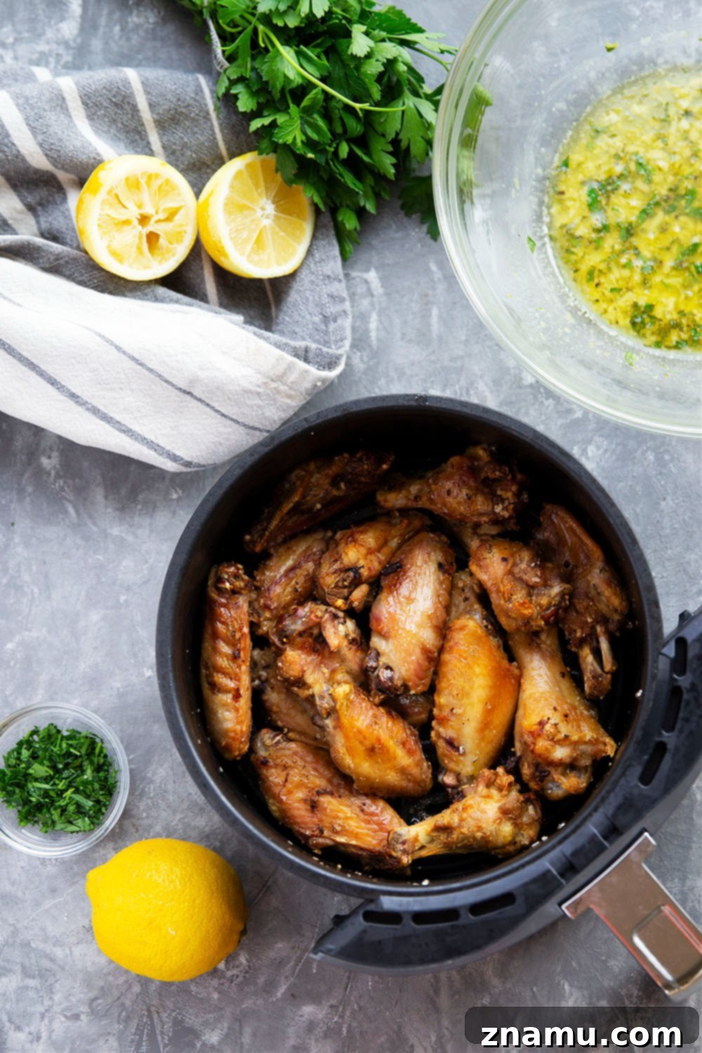 Crispy Air Fryer Lemon Garlic Wings 3 Close-up of golden brown air fryer chicken wings, coated in lemon garlic sauce, ready to be devoured.