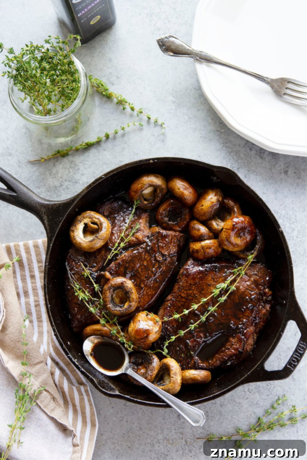Juicy balsamic glazed sirloin steaks with sautéed mushrooms in a single skillet.