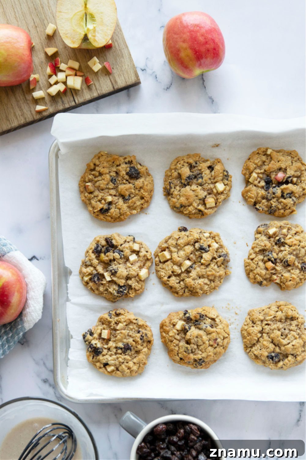 Sweetly Glazed Apple & Raisin Oatmeal Cookies 4 Freshly baked Oatmeal Raisin Apple Cookies cooling on a wire rack.
