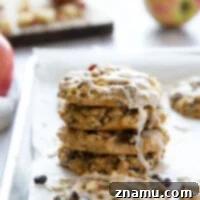 Oatmeal raisin apple cookies feature a perfectly soft oatmeal cookie base with chewy raisins, tender apple chunks, and a creamy spiced glaze.