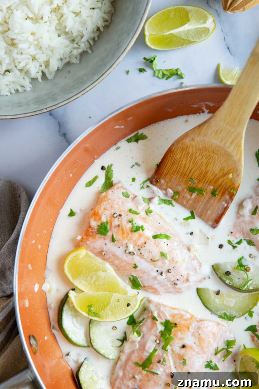 Creamy Coconut Salmon Skillet 3 Close-up of creamy coconut milk salmon in a skillet, garnished with fresh cilantro.