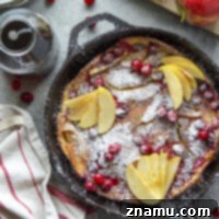 Stuffed with sautéed apples and tart cranberries, this cranberry apple dutch baby is a simple fall breakfast that's always impressive! Serve slices with powdered sugar and plenty of maple syrup.