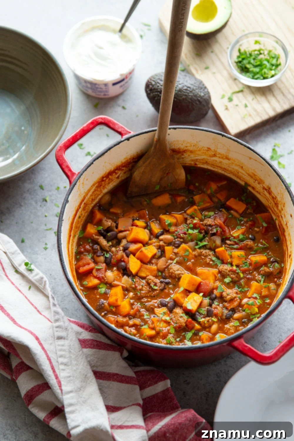 Bold Chipotle Chicken Sweet Potato Chili 4 A large pot of Chipotle Chicken Sweet Potato Chili simmering on the stove, showcasing the vibrant colors of the ingredients before serving.