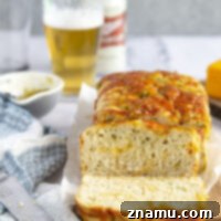 Green chile cheddar beer bread features spicy green chiles and gooey cheddar in a soft, flavorful beer quick bread that's perfect for snacking or a game day appetizer!