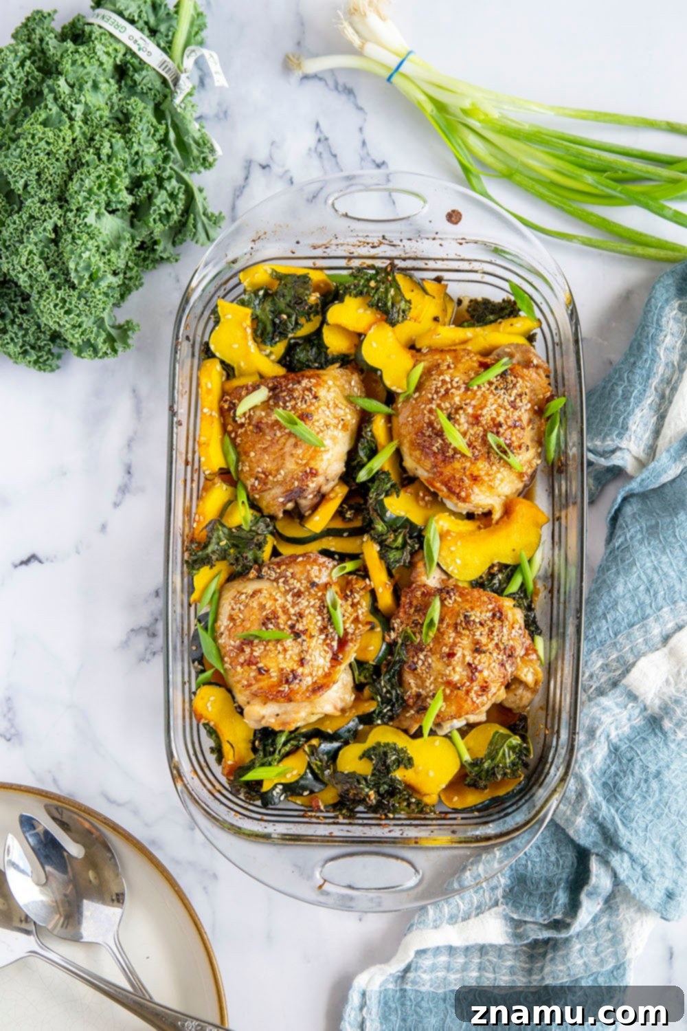 Honey Sesame Glazed Chicken Thighs with Roasted Acorn Squash and Sautéed Kale 2 Honey sesame chicken thighs are roasted with tender acorn squash and kale in a flavorful honey sesame sauce for an easy dinner made in less than an hour!