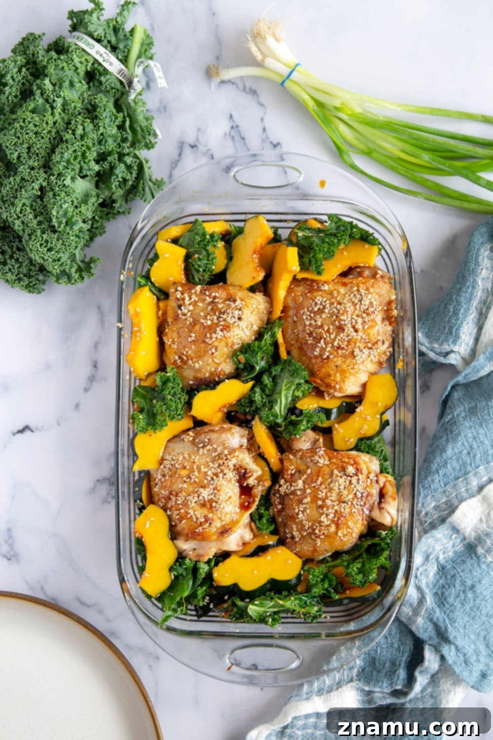 Honey Sesame Glazed Chicken Thighs with Roasted Acorn Squash and Sautéed Kale 4 Honey sesame chicken thighs are roasted with tender acorn squash and kale in a flavorful honey sesame sauce for an easy dinner made in less than an hour!