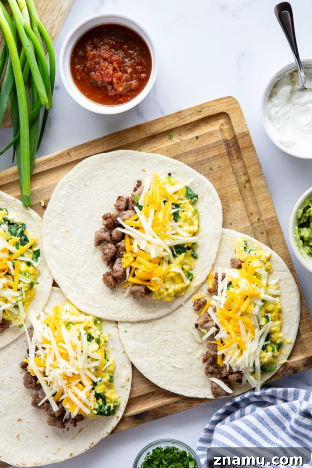 Wholesome Breakfast Quesadillas 3 Crispy breakfast quesadillas with a rich filling of scrambled eggs, sausage, and spinach, presented on a plate for a hearty and healthy morning meal.