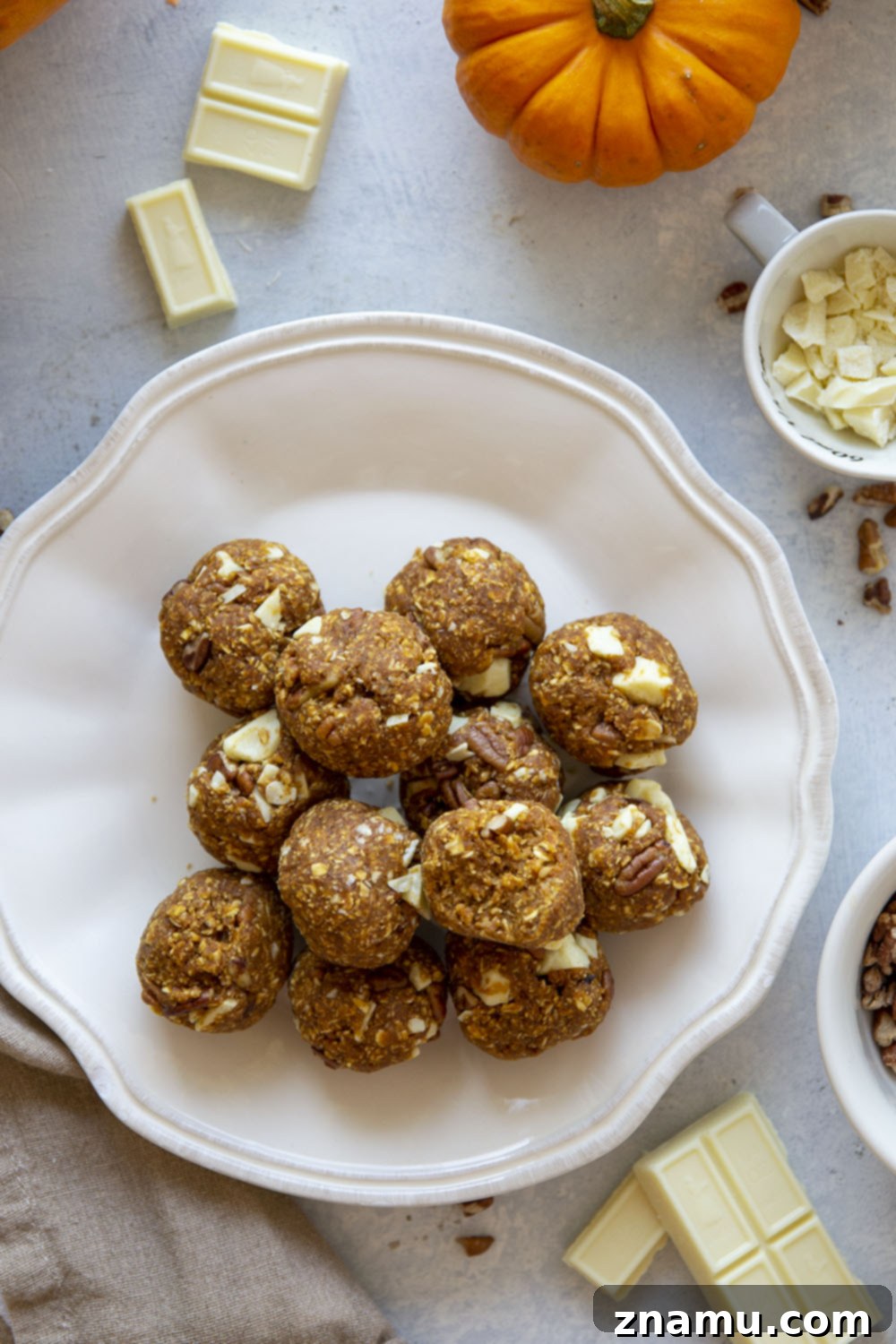 Pumpkin Spice Energy Gems 5 Individual no-bake pumpkin energy bites arranged on a serving plate.