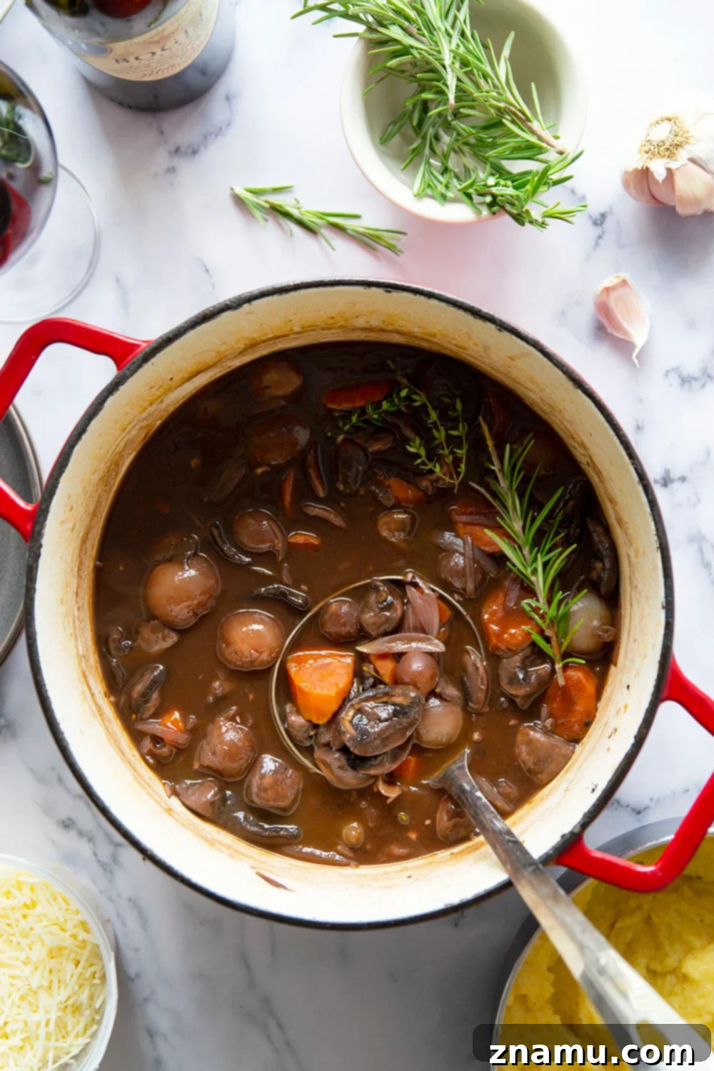 Hearty Mushroom Bourguignon with Velvety Asiago Polenta 5 Mushroom bourguignon features a savory red wine mushroom sauce served on top of creamy asiago polenta.