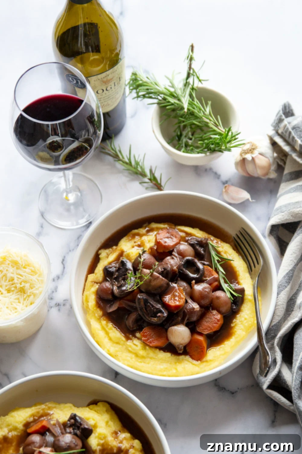 Hearty Mushroom Bourguignon with Velvety Asiago Polenta 6 Mushroom bourguignon features a savory red wine mushroom sauce served on top of creamy asiago polenta.