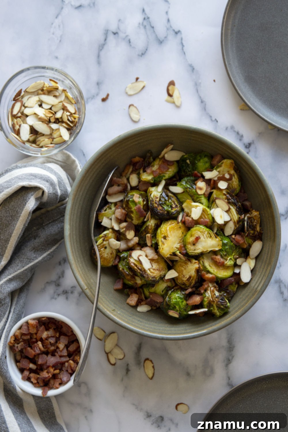 Blistered Air Fryer Brussels Sprouts with Hot Honey Butter 2 Crispy Air Fryer Brussels Sprouts coated in sweet and spicy hot honey butter, garnished with toasted almonds and crumbled bacon.