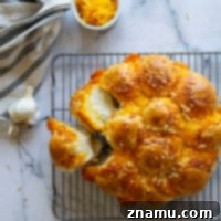 Baked in a cast iron skillet and exploding with gooey cheddar and flavorful garlic butter, these garlic cheddar skillet dinner rolls are the perfect bread side for any dinner!