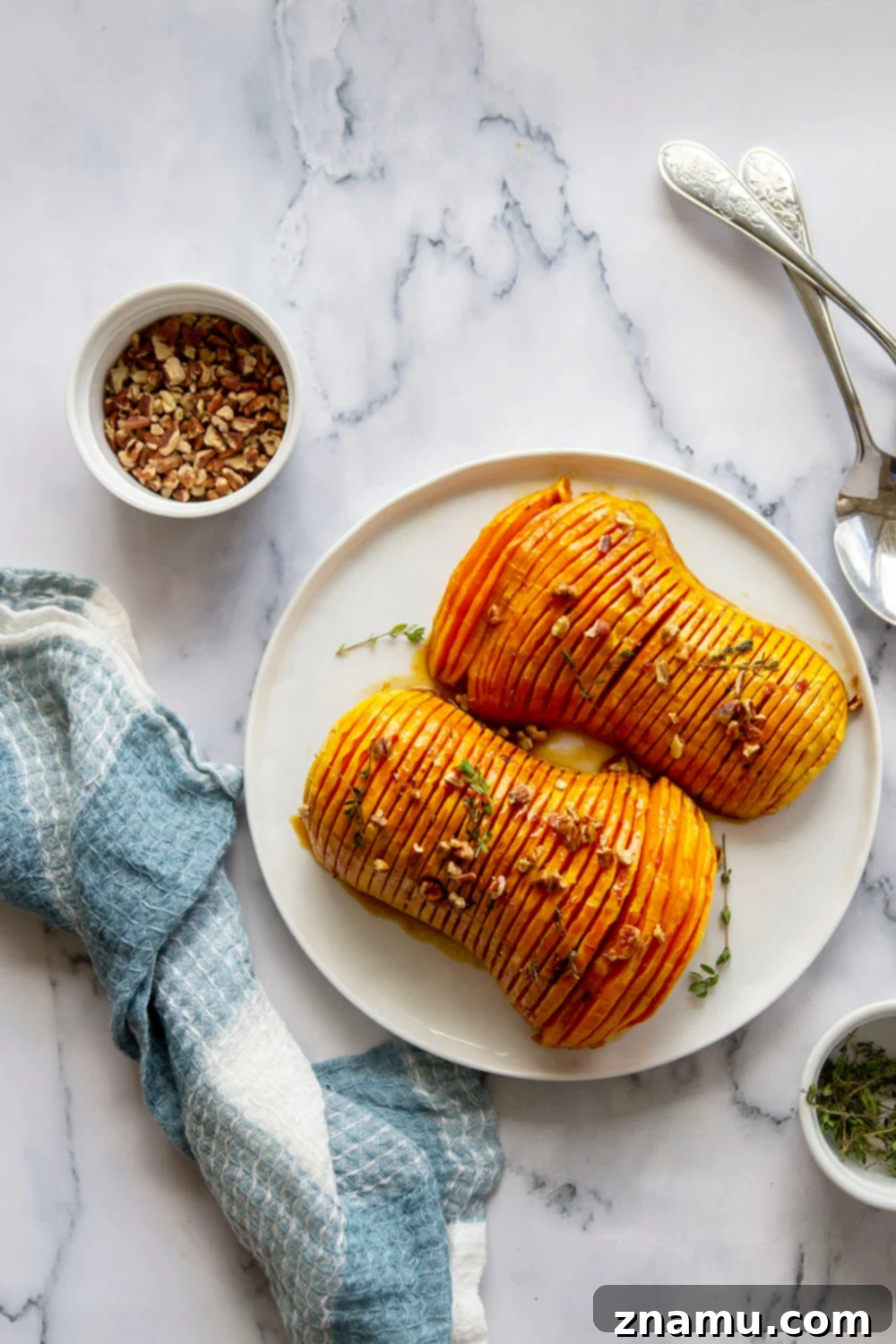 Maple Brown Butter Hasselback Butternut Bliss 6 Hasselback butternut squash is roasted with a sweet maple browned butter sauce and the perfect impressive side dish to put on your holiday table!