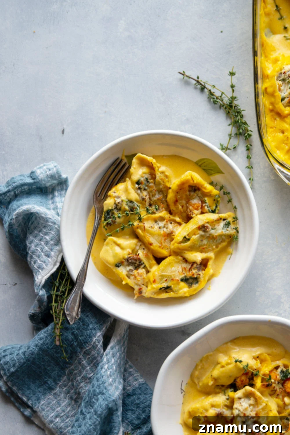 Golden Butternut Sausage Stuffed Shells 2 Creamy butternut squash alfredo sauce and flavorful sausage are featured in these luscious butternut squash stuffed shells. - easy to make ahead of time and perfect for any dinner occasion!