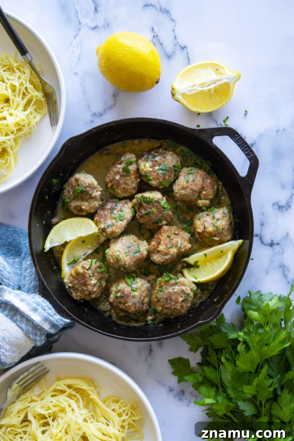 Piccata-Style Chicken Meatballs 4 A vibrant selection of ingredients for homemade chicken piccata meatballs, including ground chicken, lemon, capers, fresh parsley, garlic, and white wine