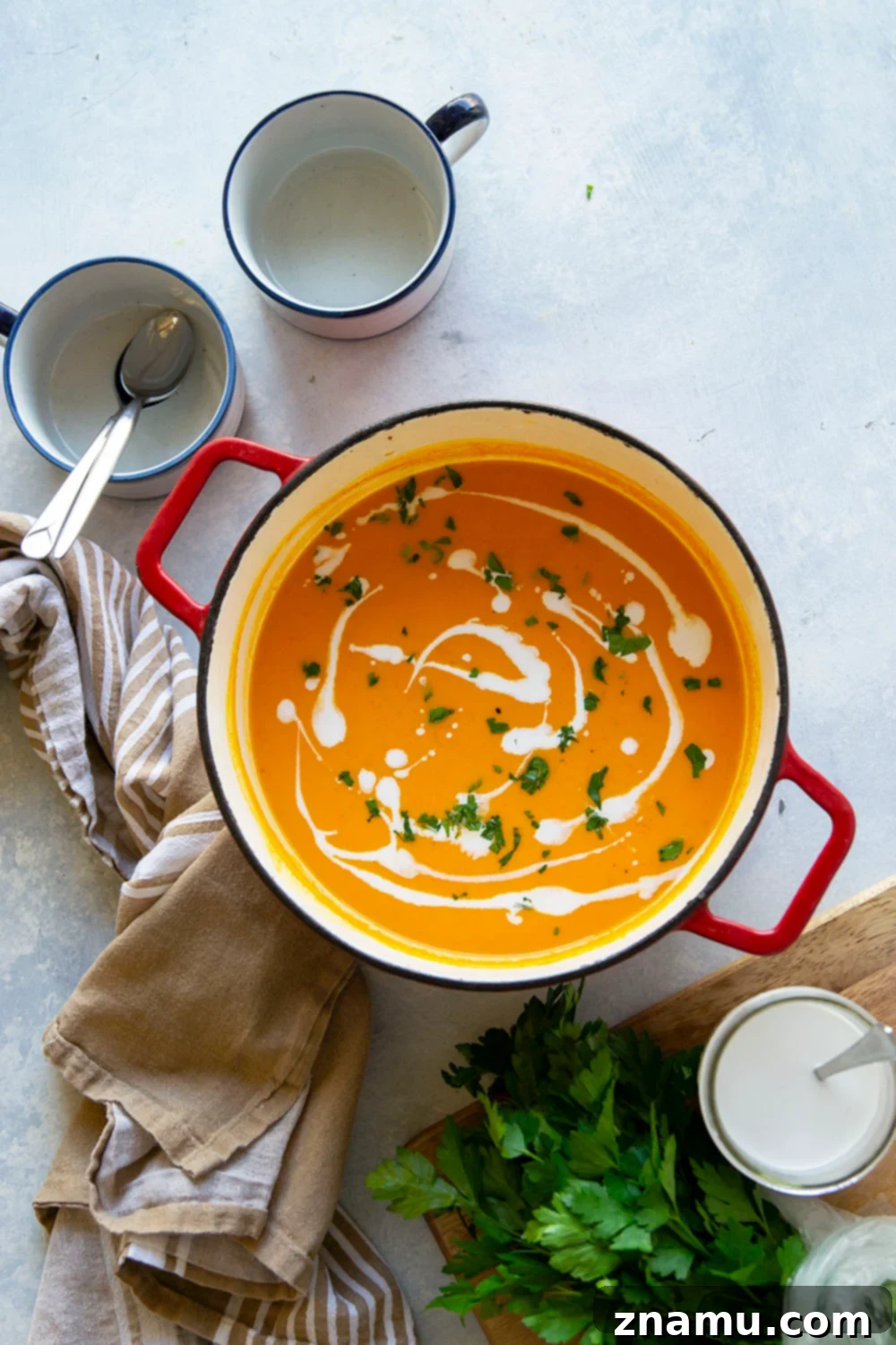 Sweet & Smoky Butternut Squash Soup with Coconut 2 Creamy vegan butternut squash soup with roasted red peppers and coconut milk, garnished with fresh parsley.
