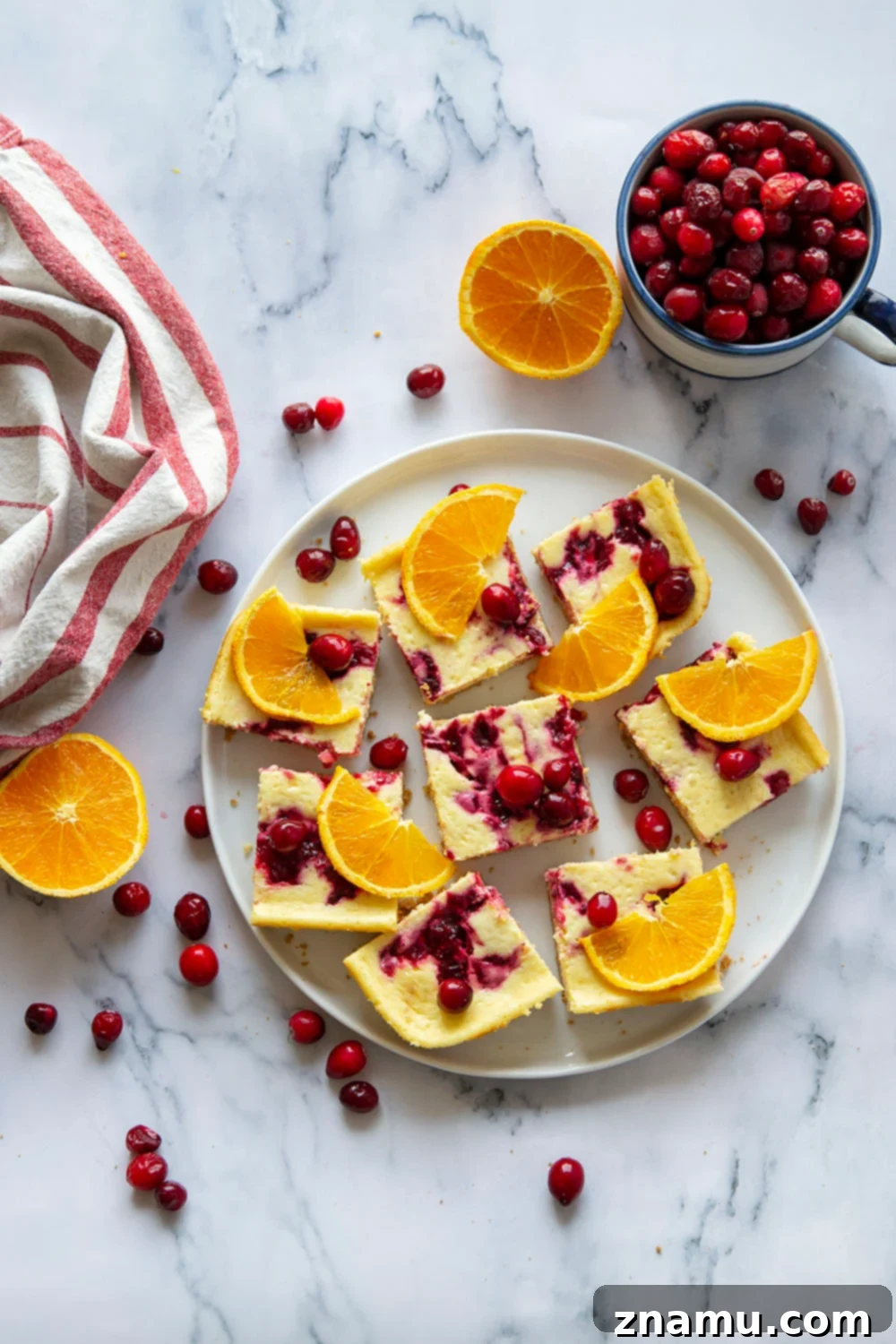 Zesty Orange Cranberry Cheesecake Bars 4 Swirled with a tangy cranberry sauce and loaded with tons of orange flavor, these orange cranberry cheesecake bars are easy to make and a standout on any holiday table!