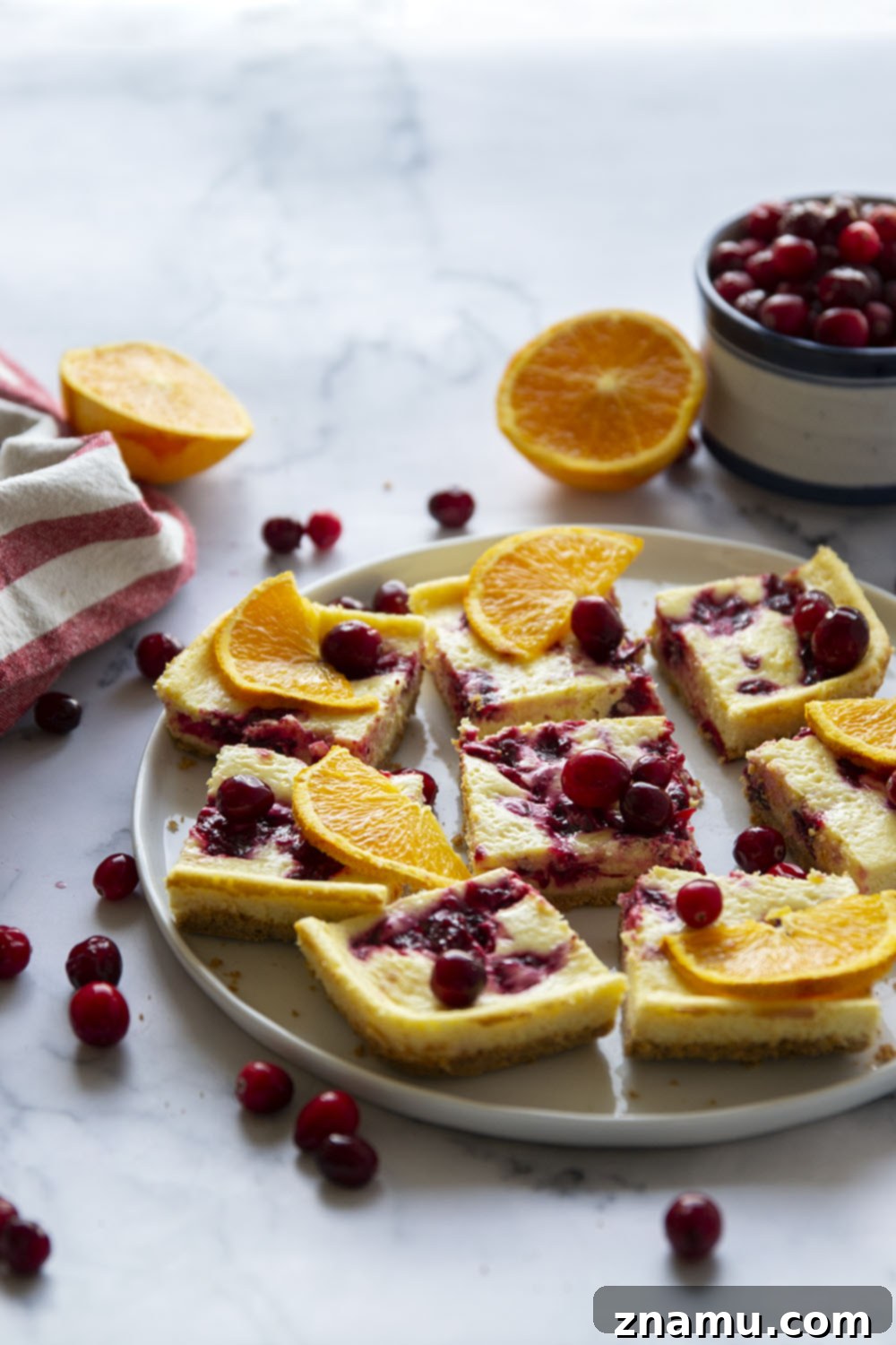 Zesty Orange Cranberry Cheesecake Bars 5 Swirled with a tangy cranberry sauce and loaded with tons of orange flavor, these orange cranberry cheesecake bars are easy to make and a standout on any holiday table!