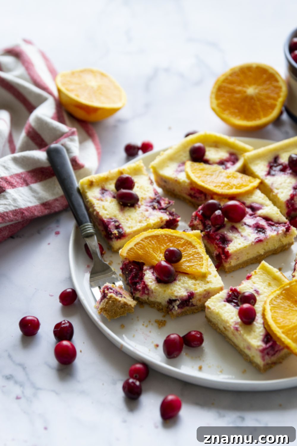 Zesty Orange Cranberry Cheesecake Bars 6 Swirled with a tangy cranberry sauce and loaded with tons of orange flavor, these orange cranberry cheesecake bars are easy to make and a standout on any holiday table!