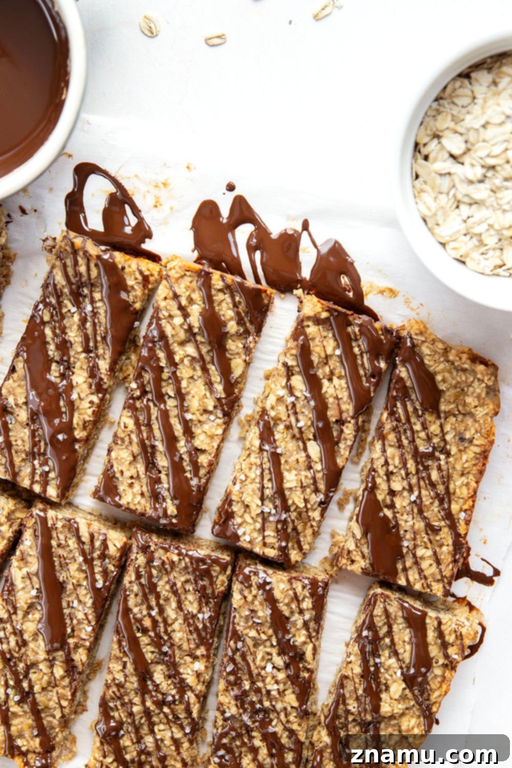 Chewy Peanut Butter Banana Oatmeal Bars 6 A stack of golden brown peanut butter banana oat bars, showcasing their texture.