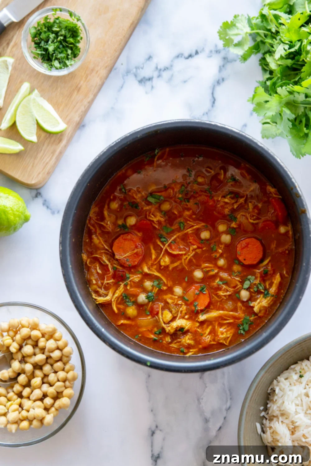 Moroccan Chicken Stew in the Instant Pot 3 Close-up of Moroccan Chicken Stew in an Instant Pot, showing the rich, spiced broth and hearty ingredients.