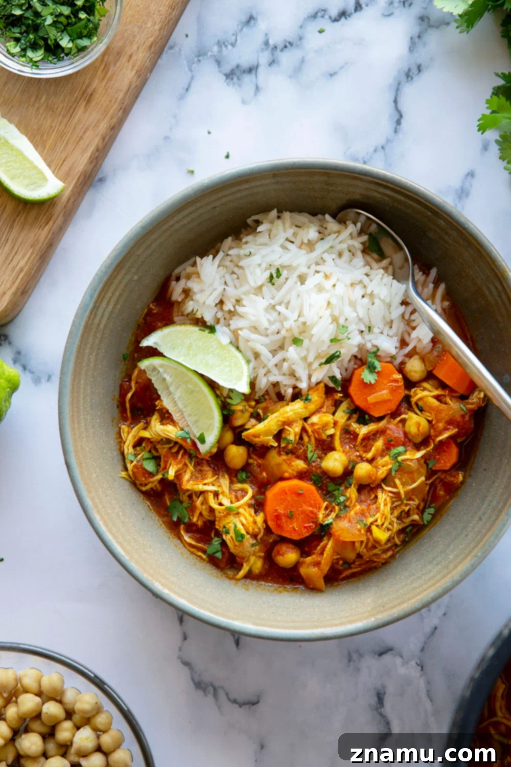 Moroccan Chicken Stew in the Instant Pot 4 A serving of Instant Pot Moroccan Chicken Stew with fluffy white rice, fresh lime, and cilantro.