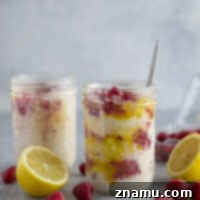 Tangy lemon curd and a juicy fresh raspberry sauce are swirled into these creamy overnight oats for an easy make-ahead breakfast treat!