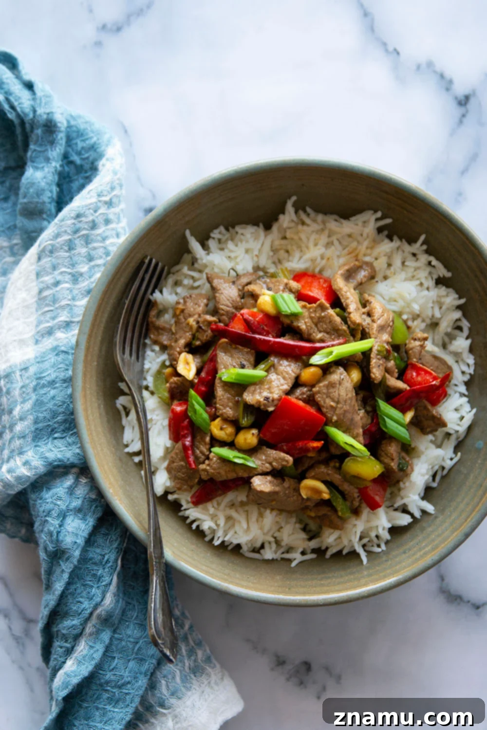 Szechuan Chili Peanut Beef 2 Kung Pao Beef with tender marinated beef, spicy chili peppers, and crunchy peanuts, served over rice. This homemade version is ready in under an hour.