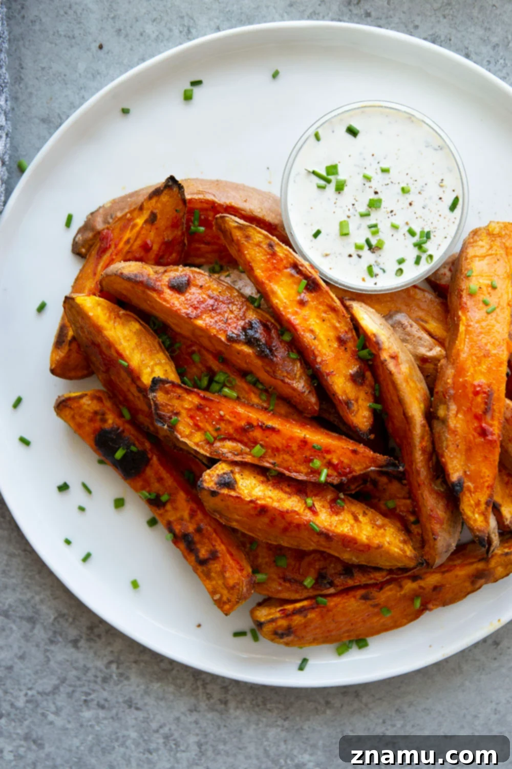 Fiery Harissa Sweet Potato Wedges with Cool Garlic Herb Aioli 2 Harissa roast sweet potato wedges pack a flavorful punch of heat and are perfectly crispy on the outside and fluffy on the inside.-- serve with a garlic herb aioli for dipping!