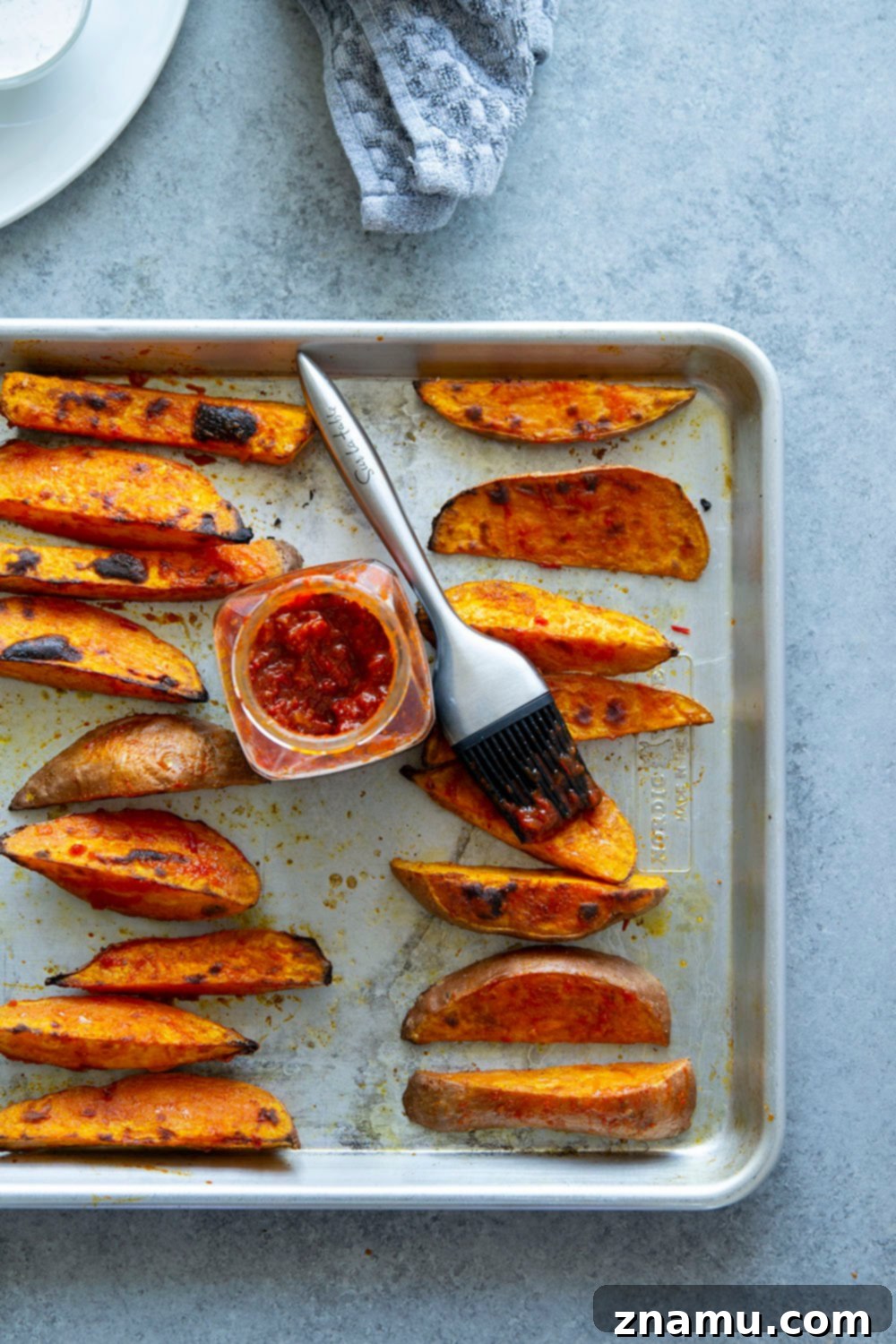 Fiery Harissa Sweet Potato Wedges with Cool Garlic Herb Aioli 3 Harissa roast sweet potato wedges pack a flavorful punch of heat and are perfectly crispy on the outside and fluffy on the inside.-- serve with a garlic herb aioli for dipping!