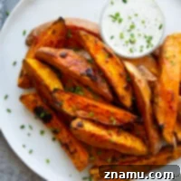 Harissa roast sweet potato wedges pack a flavorful punch of heat and are perfectly crispy on the outside and fluffy on the inside.-- serve with a garlic herb aioli for dipping!