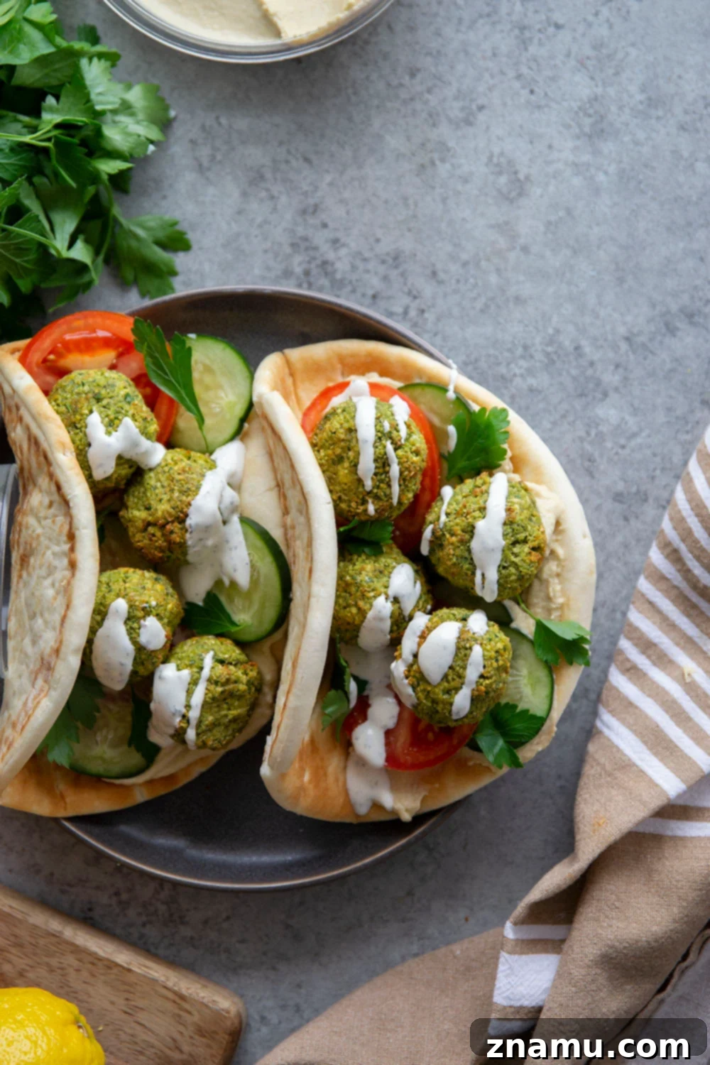 Crispy Air Fryer Falafel 6 A plate of freshly air-fried falafel served with pita bread, hummus, and fresh vegetables, ready to be enjoyed.