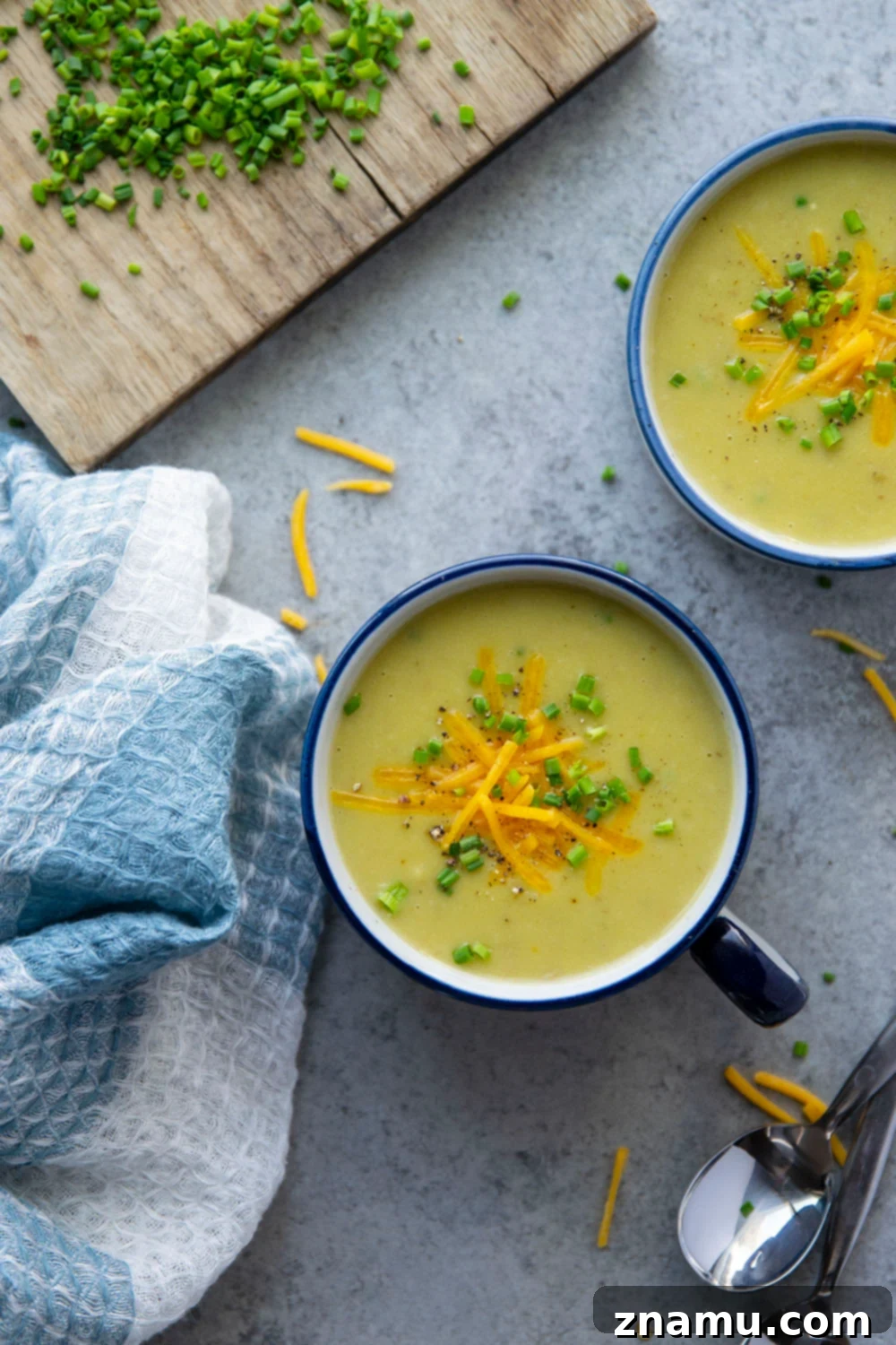 A large pot of creamy Instant Pot Potato Leek Soup, garnished with fresh herbs, ready to be served or stored.