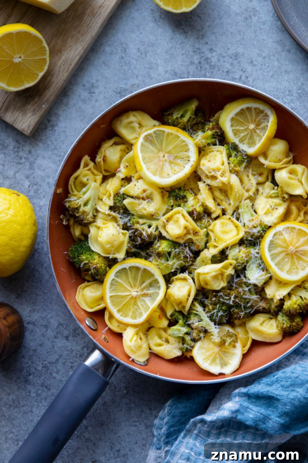Zesty Roasted Broccoli Tortellini 3 Close-up of freshly made Lemon Roasted Broccoli Tortellini, showcasing the golden-brown broccoli, pillowy tortellini, and a generous sprinkle of Parmesan cheese.