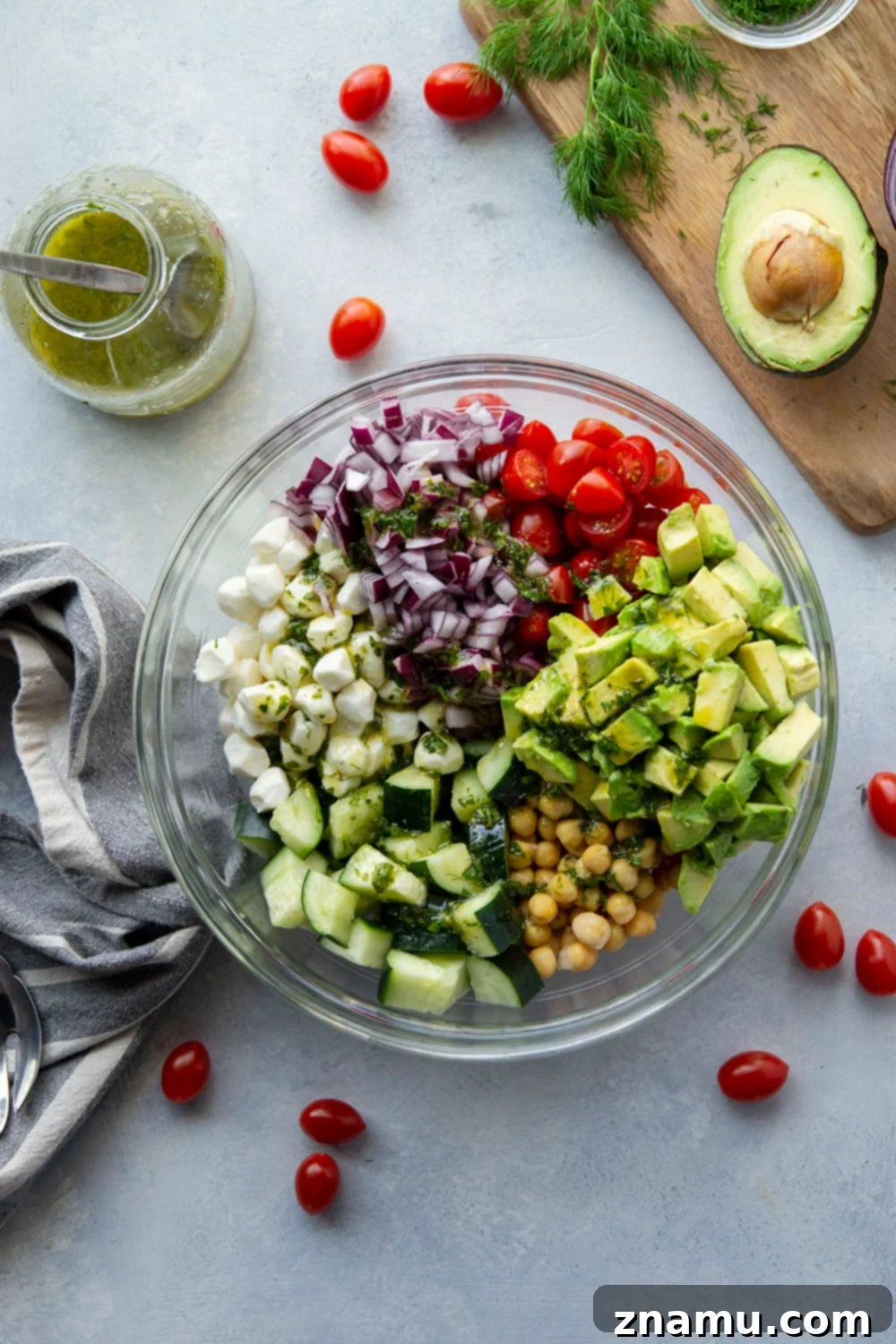 Creamy Italian Avocado Chickpea Salad 4 A close-up shot of the vibrant Italian Avocado Chickpea Salad, showing the beautiful mix of diced avocado, chickpeas, cherry tomatoes, and fresh herbs, all coated in a light dressing, emphasizing freshness and color.