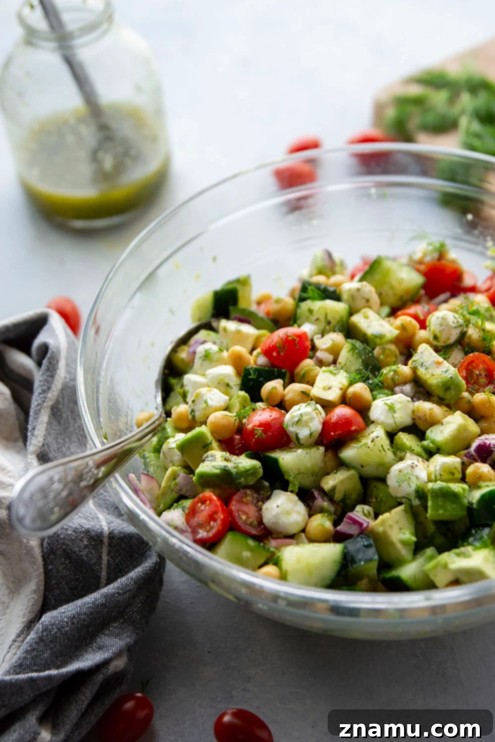 Creamy Italian Avocado Chickpea Salad 6 A vibrant and colorful Italian Avocado Chickpea Salad in a bowl, showcasing its fresh ingredients and inviting texture. The focus is on the deliciousness and healthiness of the dish.
