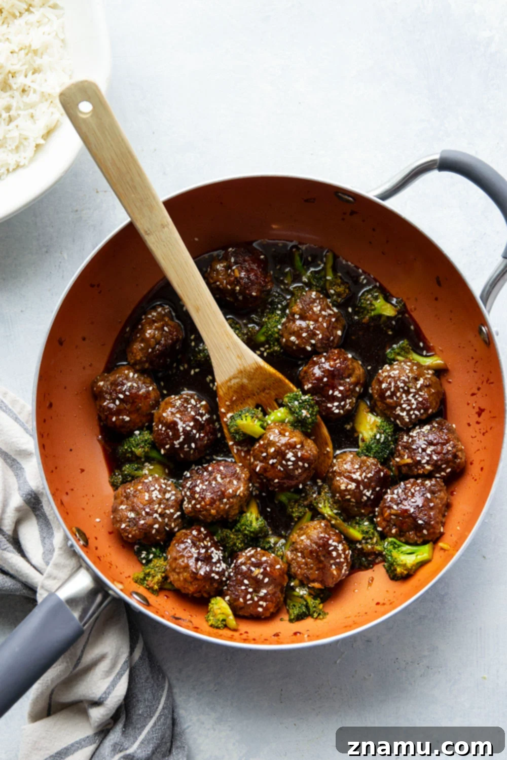 Sticky Sesame Beef & Broccoli Balls 4 Prepared beef mixture shaped into small meatballs on a plate before cooking.