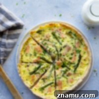 This asparagus smoked salmon quiche is absolutely stunning on any brunch table and features a buttery homemade pastry crust and silky egg filling studded with asparagus spears and flavorful smoked salmon.