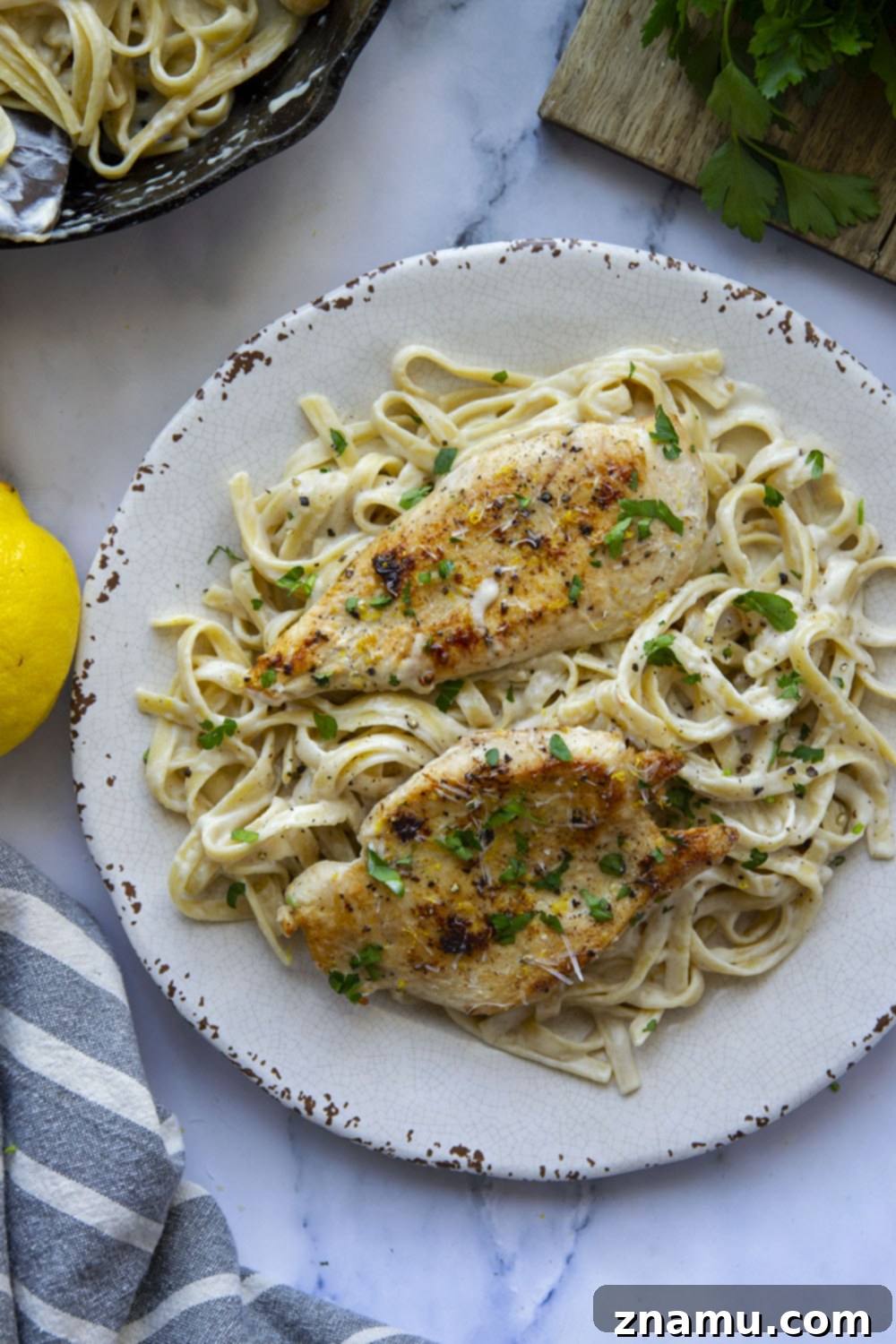 Creamy Lemon Pepper Chicken Alfredo Fettuccine 6 Overhead shot of a large skillet filled with lemon pepper chicken alfredo fettuccine.