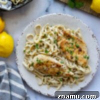 This lemon pepper chicken alfredo fettuccine features juicy lemon pepper-rubbed chicken cutlets served on a bed of luxuriously creamy fettuccine alfredo.