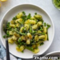 Soft and pillowy gnocchi tossed in a lemon pesto sauce with peas and asparagus is the perfect spring side dish for any occasion! This lemon pesto gnocchi comes together in minutes and is exploding with green goodness.